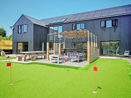 a house with a yard with a table and chairs at The Black Barn in Marldon