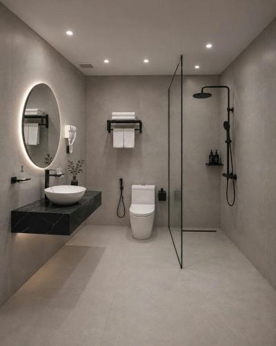 a bathroom with a toilet and a sink and a mirror at Dragon Hotel in Rạch Giá