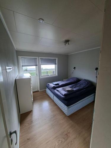 a bedroom with a bed in a small room at Koselig hus med flott utsikt in Vossevangen