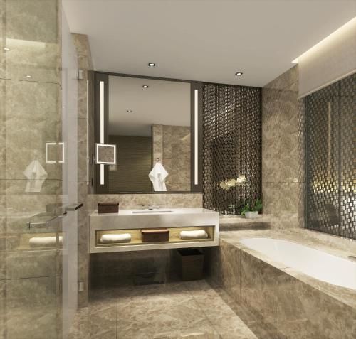 a bathroom with a tub and a sink at Zhenjiang Marriott Hotel in Zhenjiang