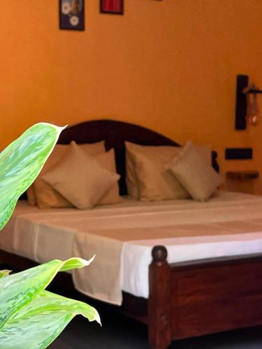a bed with white sheets and pillows in a bedroom at Rasa Homestay in Dickwella