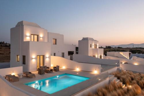 a villa with a swimming pool at night at Eupnoia Villas in Agios Arsenios