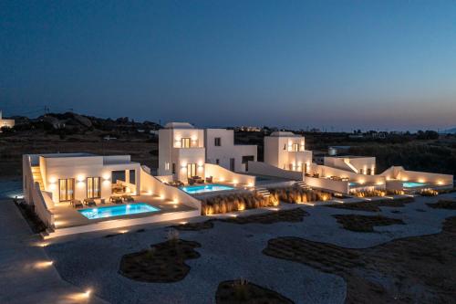 a large white building with lights at night at Eupnoia Villas in Agios Arsenios
