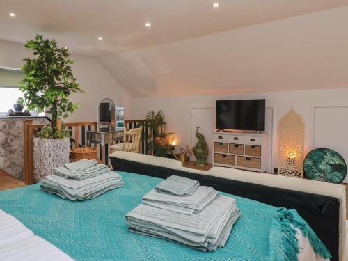 a room with a bed with towels on top of it at The Retreat in Goole