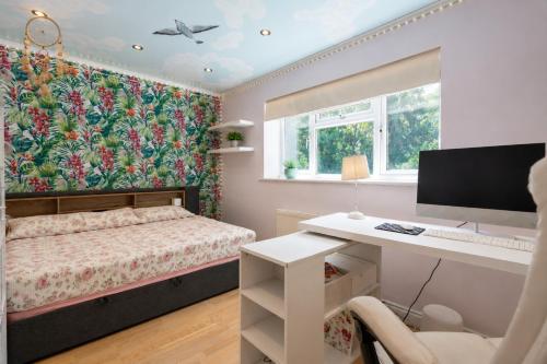 a bedroom with a bed and a desk with a computer at K Suites - Liverpool Road Worcester with Hot Tub in Worcester