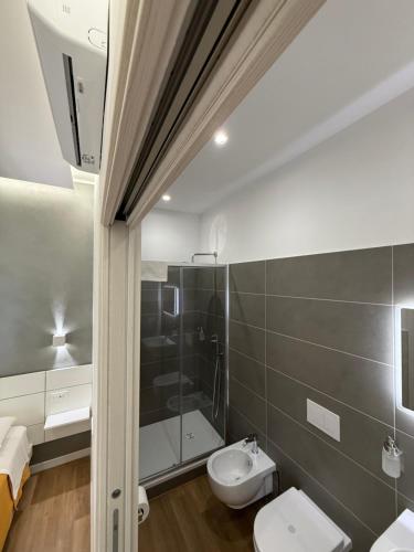 a bathroom with a shower and a toilet and a sink at B&B Ciocca II in Campobasso