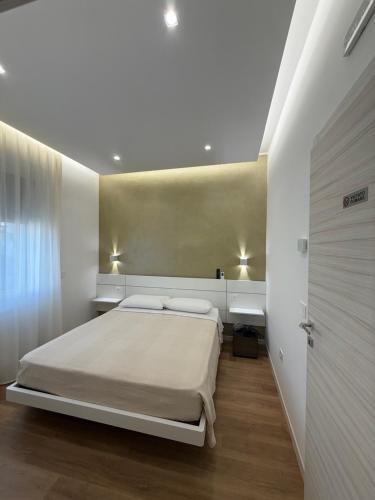 a bedroom with a large bed and a door at B&B Ciocca II in Campobasso