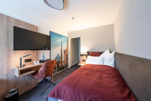a hotel room with a bed and a desk at Krone 1516 in Elchingen