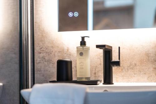 a bottle of sunscreen sitting on a bathroom sink at Krone 1516 in Elchingen