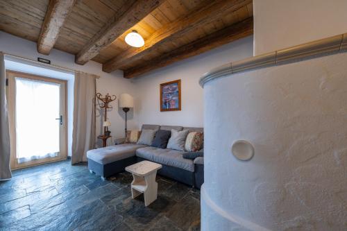 a living room with a couch and a table at Agriturismo Botondoro in San Niccolò Comèlico