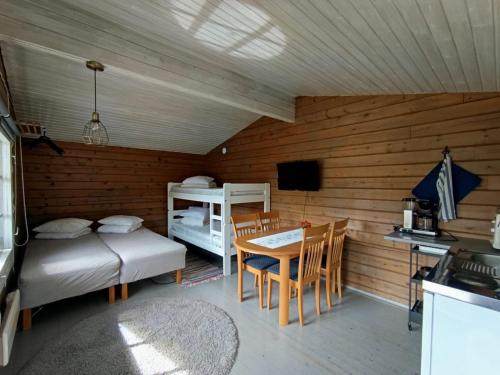 a room with a bed and a table and a bed and a desk at Arctic Camping Finland in Pello