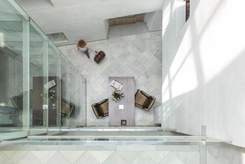 a woman walking down a staircase in a building at Hotel Ramblas Internacional in Barcelona