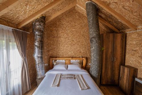 a bedroom with two beds in a brick wall at HotelRestaurant Gështenja in Suharekë