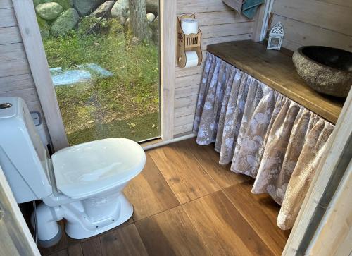 a bathroom with a toilet and a sink at Glamping Tent Tammemäe in Haapsi