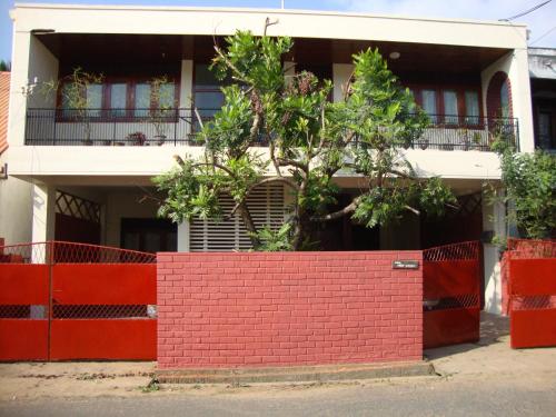 a red brick wall in front of a house at Blue Waters in Matara