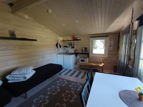 a living room with a bed and a kitchen at Arctic Camping Finland in Pello