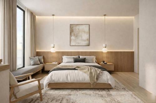 a bedroom with a large bed and a chair at THE OneThird HAKUBA Slopefront Villas in Hakuba