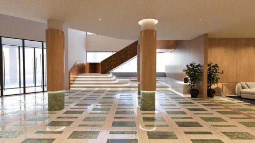 a lobby with a staircase in a building at The Nishat Hotel Margala in Islamabad