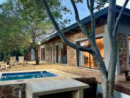 a house with a swimming pool in the yard at Athule Inn - Cradle in Hekpoort