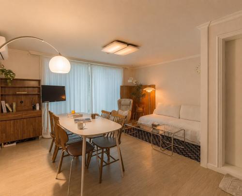 a room with a table and a bed and a bedroom at 수지의 하우스 in Cheonan