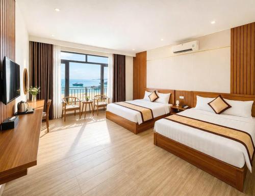 a hotel room with two beds and a television at Hottel HÙNG PHƯƠNG cô tô in Đảo Cô Tô