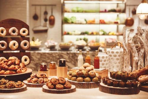 a table with many different types of donuts and pastries at ANA InterContinental Ishigaki Resort by IHG in Ishigaki Island