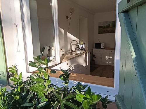a bathroom with a sink and a large mirror at L'Hirondelle in Fourges