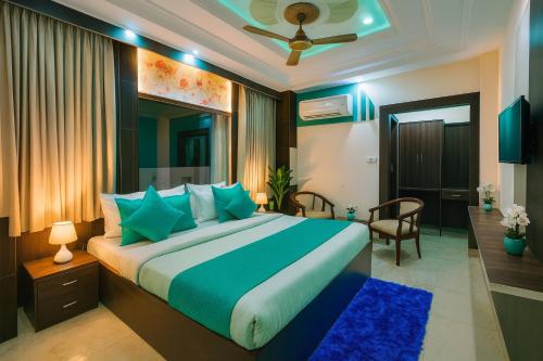 a bedroom with a large bed with blue pillows at Hotel Ramawati Near Ganga Ghat, Haridwar in Haridwār