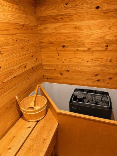 a small kitchen with a stove in a wooden room at YASAKA Hotel in Kagoshima