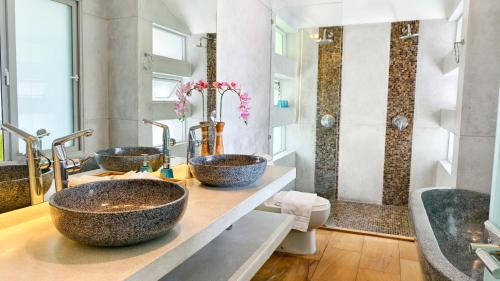 a bathroom with three sinks and a shower at Villa Monsoon in Nathon Bay