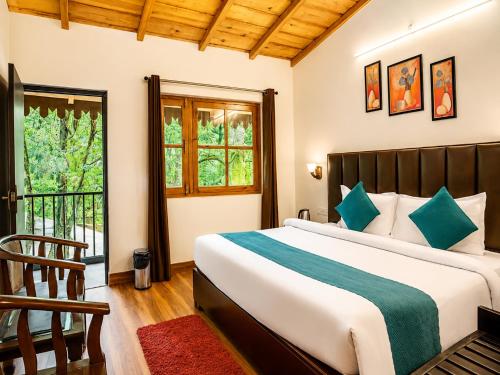 a bedroom with a bed and a balcony at The Woods Boho in Nainital