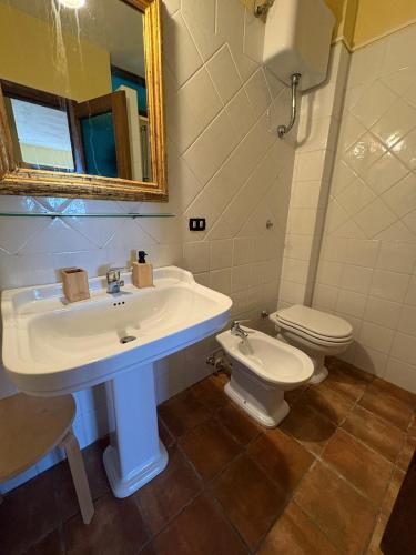 a bathroom with a sink and a toilet at Il Ritrovo degli Angeli in San Mauro Cilento