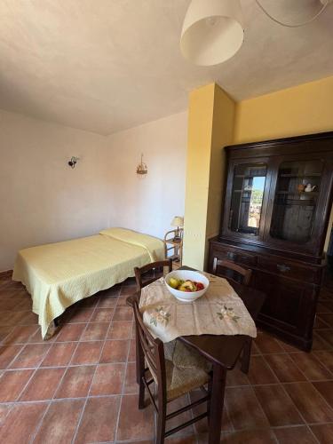 a bedroom with a bed and a table with a bowl of fruit on it at Il Ritrovo degli Angeli in San Mauro Cilento
