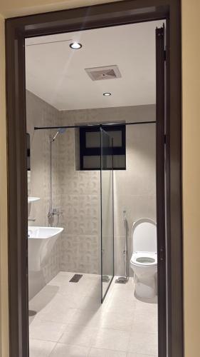 a bathroom with a shower and a toilet and a sink at برايم سيغنتشر in Al Khobar