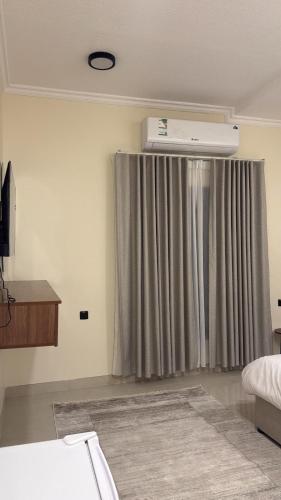 a bedroom with a bed and a window with a heater at برايم سيغنتشر in Al Khobar