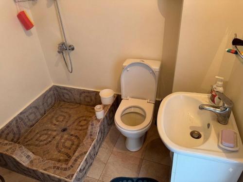 a bathroom with a toilet and a sink at Antarut Garden House in Antarut