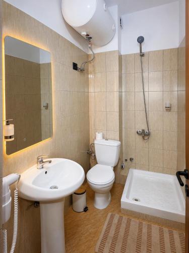a bathroom with a sink and a toilet and a tub at Azel Boutique Hotel in Draç