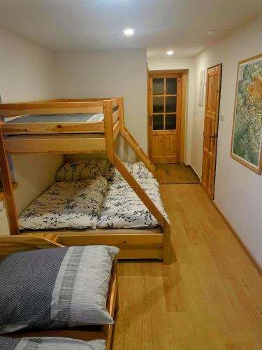 a room with two bunk beds and a hallway at Apartmán Albrechtice 97 in Albrechtice v Jizerských horách