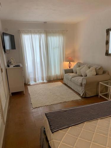 a living room with a couch and a large window at Gorgeous Apartment in Jesús in Nuestra Señora de Jesus