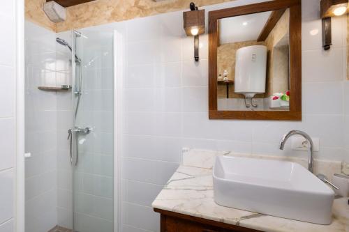 a bathroom with a sink and a shower at Holiday House - Old Olive in Porozina