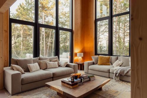 a living room with two couches and a table at Les Terrasses de Durbuy in Durbuy
