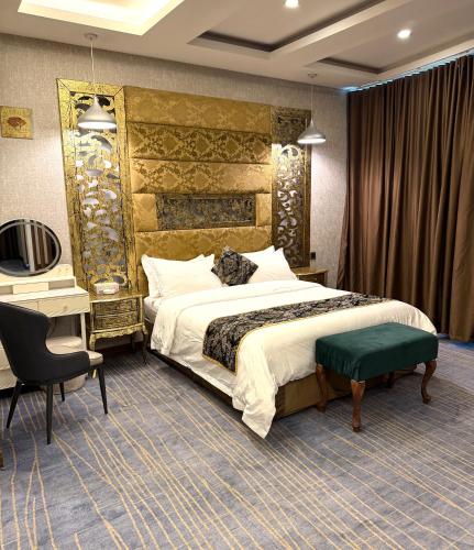 a hotel room with a bed and a desk at Bloom Hotel in Baghdād