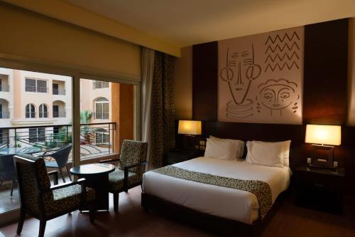 a hotel room with a bed and a balcony at هوتيل بوسيك - Bosque Hotel in Hurghada