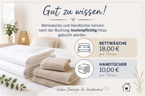 a bunch of towels on a table in a bedroom at Hausboot Optima in Wangerland