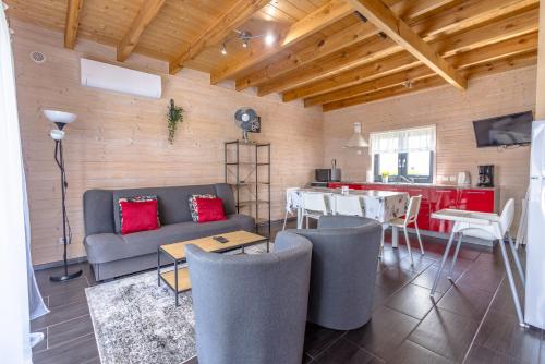 a living room with a couch and a table at Domki Kalipso in Sarbinowo