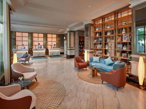 a lobby of a hotel with couches and chairs at Mövenpick Hotel Hanoi Centre in Hanoi