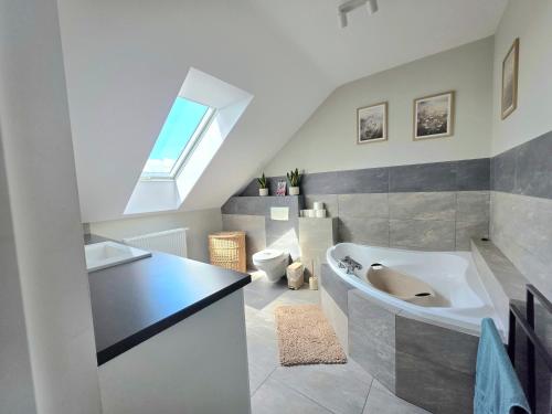a bathroom with a large tub and a sink at Komfortowy Dom Całoroczny - sauna, jacuzzi, bilard in Tyłowo