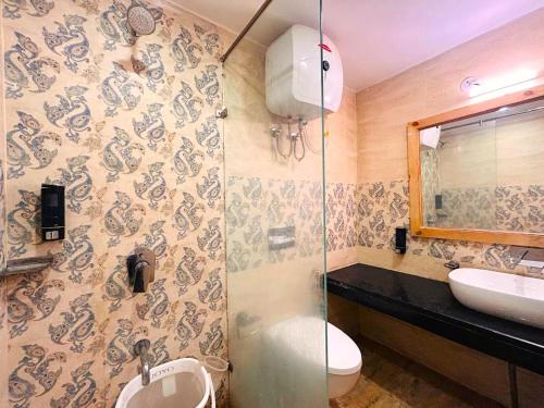a bathroom with a sink and a toilet and a shower at The Pine Woods - A Four Star Luxury Resort In Mussoorie Near JW Marriott in Mussoorie