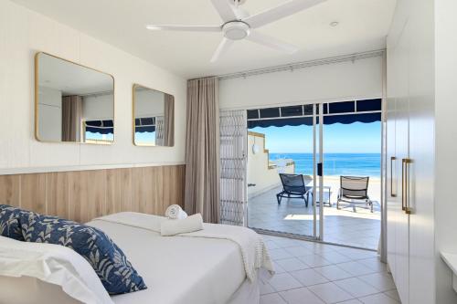 a bedroom with a bed and a view of the ocean at Club 10 Management in Ballito