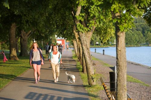 a couple of people walking a dog down a sidewalk at Best Western Motala Stadshotell in Motala